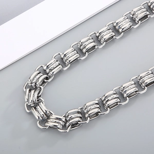 Macro detail of 15mm chunky silver chain necklace with engraved cylindrical metal links