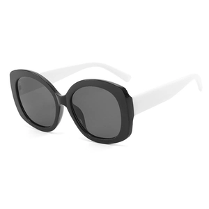2025 trendy oval sunglasses featuring large black frame and contrasting white temples