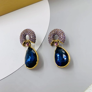 Vintage gold-plated earrings with purple crystals and blue teardrop gemstone pendants
