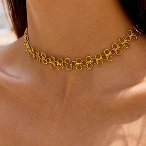 Gold-toned titanium steel choker necklace featuring interlocking infinity link patterns