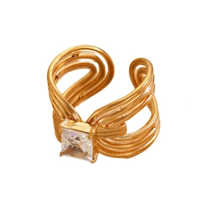 Macro detail of multi-layer gold stainless steel ring with a square-cut zircon stone
