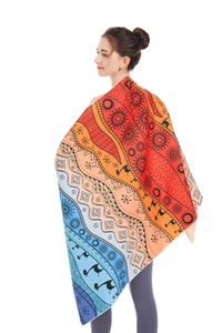 Detail of bohemian mandala microfiber beach towel with vibrant gradient patterns