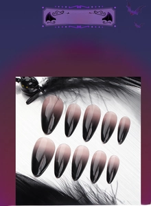 Detail of 3D Halloween almond press-on nails with black ombre design and bat elements