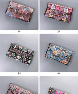 Detail view of ethnic style phone bags showing bohemian prints and hand-stitched edges