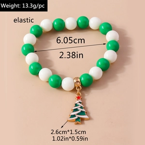 Detailed view of Christmas charm bracelet with green beads and xmas tree pendant