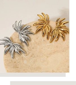 Flat lay of gold and silver 316 stainless steel half-flower fan earrings on marble tray