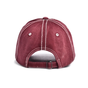 Detail of burgundy baseball cap featuring contrast stitching and adjustable metal buckle