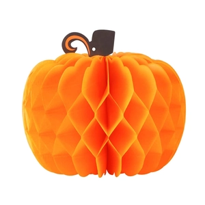 Detailed view of an orange honeycomb paper pumpkin ornament for Thanksgiving party decor