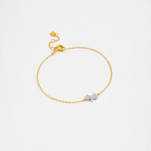 Detailed close-up of S925 sterling silver golden bracelet with dog pendant and cubic zirconia