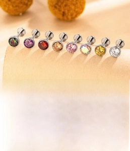 Macro shot of titanium alloy labret stud with inlaid zircon and internal thread detail