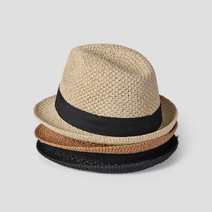 Vertical stack of hand-woven straw fedora hats with black ribbons in beige, tan and black