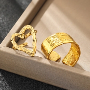 Detail of 18K gold plated heart ring and textured wide band on jewelry box