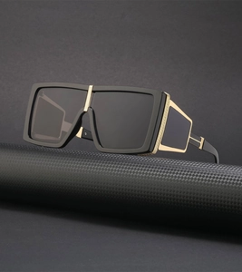 Detail of steampunk square sunglasses with golden T-hinges and side shield protection