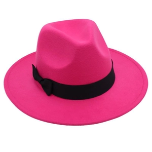 Detail of rose red wool felt fedora featuring a classic black ribbon bow accent