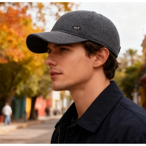 Close-up of a dark grey knitted baseball cap with SPORT label and warm texture