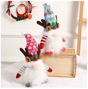 Macro view of glowing Christmas gnomes with knit heart hats, antlers and bell details