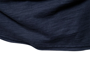 Detailed macro view of navy blue slub cotton fabric with double-needle stitching
