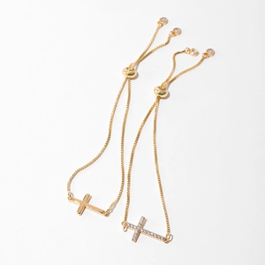 Detail of adjustable gold cross bracelets with plain and zircon pavé designs