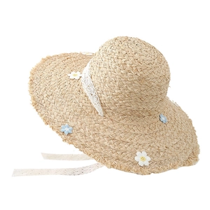 Handwoven straw hat with white lace ribbon, daisy flowers and frayed wavy brim design