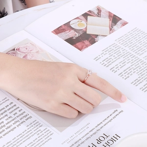 Close-up of rose gold minimalist ring with a rectangle-cut zircon on a fashion magazine