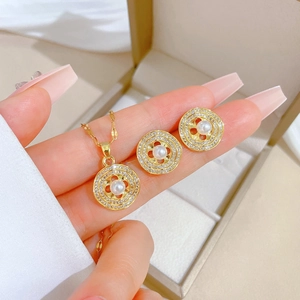 Elegant gold titanium steel jewelry set featuring round pearl necklace and stud earrings