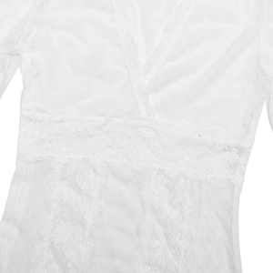 Detail of white lace V-neck dress featuring delicate floral embroidery and mesh texture