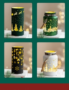 Close-up of glowing metal Christmas lanterns with deer and snowflake cutout patterns