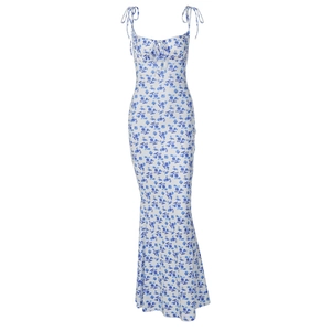 Detail view of white floral summer dress with blue flower prints and thin lace-up straps