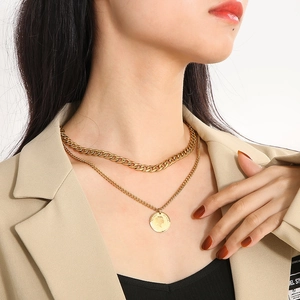 Vintage double layer gold coin necklace with Elizabeth II pendant on a model