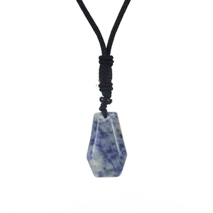 Detailed view of hexagonal natural blue sodalite stone pendant with woven black cord