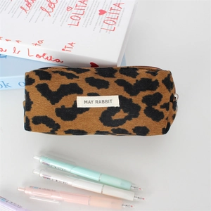 Close-up of leopard print corduroy makeup bag with white label and zipper detail