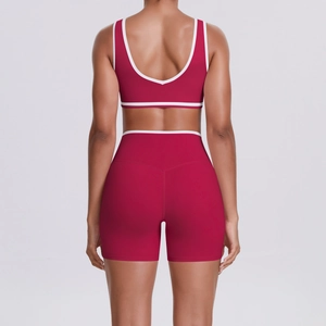 Close-up of the U-shaped back design and white trim on the burgundy yoga sports bra
