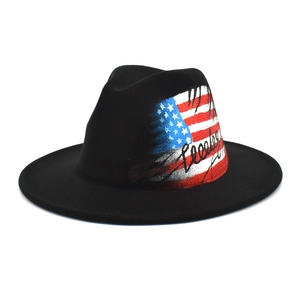 Detail of black fedora hat featuring artistic American flag print and stylized lettering