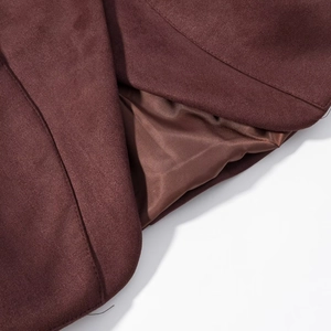 Detail of premium burgundy faux suede fabric with smooth satin lining and expert stitching