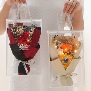 Handheld transparent gift bags with soap rose bouquets and warm LED fairy light strings
