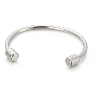 Polished silver cuff bracelet with delicate floral engravings on cylindrical ends