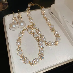 Elegante set di gioielli a fiore dorato con perle e strass in scatola regalo