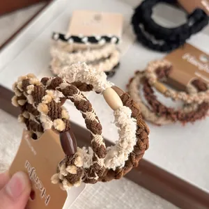 Elegant earth-tone plush braided hair ties set with oval beads on display cards