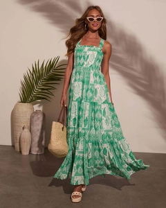 Detail of bohemian green and white floral print on tiered maxi dress with wide straps