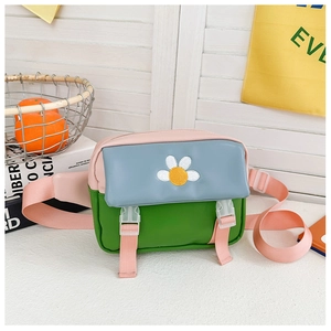 Detailed view of kids crossbody bag featuring daisy embroidery and tricolor PU leather design