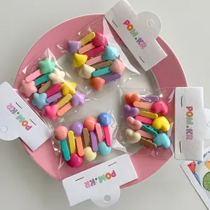 Close-up of colorful macaron hair clips in star, heart, and geometric shapes for kids