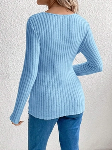Close-up of blue knit maternity top showing ribbed texture and back tie detail