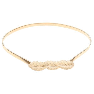 Detailed close-up of golden metal leaf buckle on an elastic spring waist belt