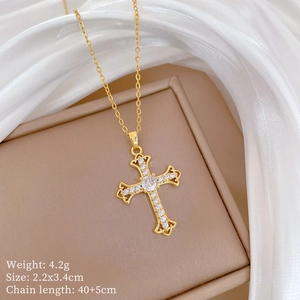 Macro view of gold cross necklace with sparkling zircons and detailed product dimensions