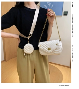 White quilted crossbody bag with gold chain and round coin purse shown on model
