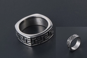Macro detail of men's square titanium steel ring with continuous Greek key pattern