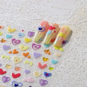Macro shot of 3D colorful heart embossed nail art stickers on gradient nails