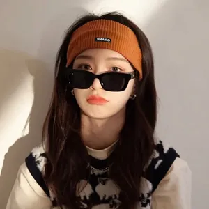 Caramel orange knitted sports headband with retro square sunglasses worn by fashion model