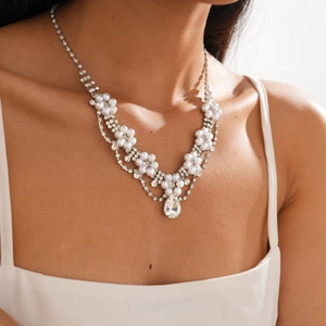 Detail of luxury double-layered necklace featuring faux pearls and water drop diamond pendant
