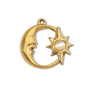 Macro shot of gold celestial sun and moon pendant featuring a white natural stone inlay